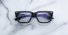 Jacques Marie Mage Yoshi in Black optical frame featuring bold geometric lenses and sculpted acetate front