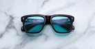 Jacques Marie Mage Yves square black sunglasses with blue lenses, front angle view, UV protection.