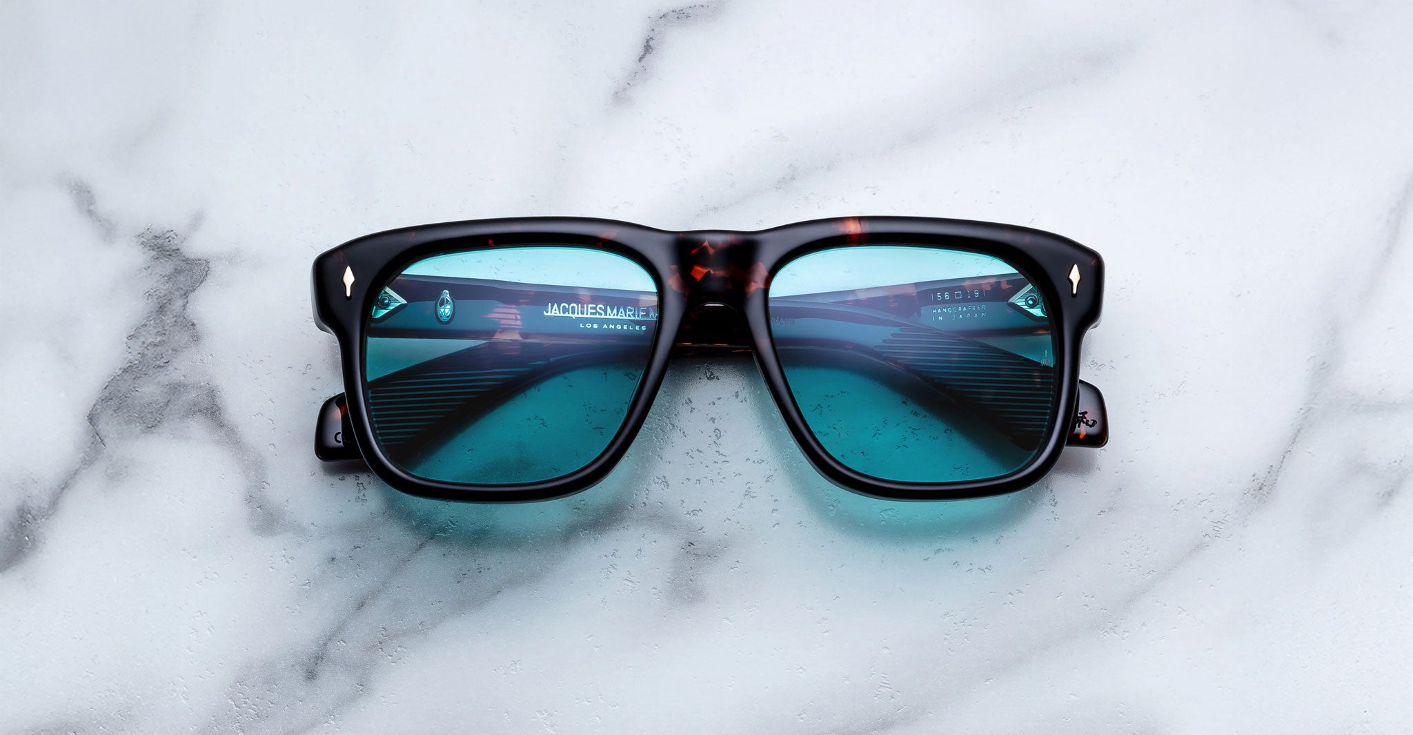 Jacques Marie Mage Yves square black sunglasses with blue lenses, front angle view, UV protection.