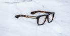 Jacques Marie Mage Yves rectangular tortoiseshell eyeglasses with silver accents, top view.