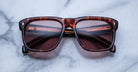 Jacques Marie Mage Yves tortoiseshell square sunglasses with UV-protected tinted lenses, top view.