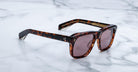 Jacques Marie Mage Yves tortoiseshell sunglasses with brown lenses and wide arms, shown from above.