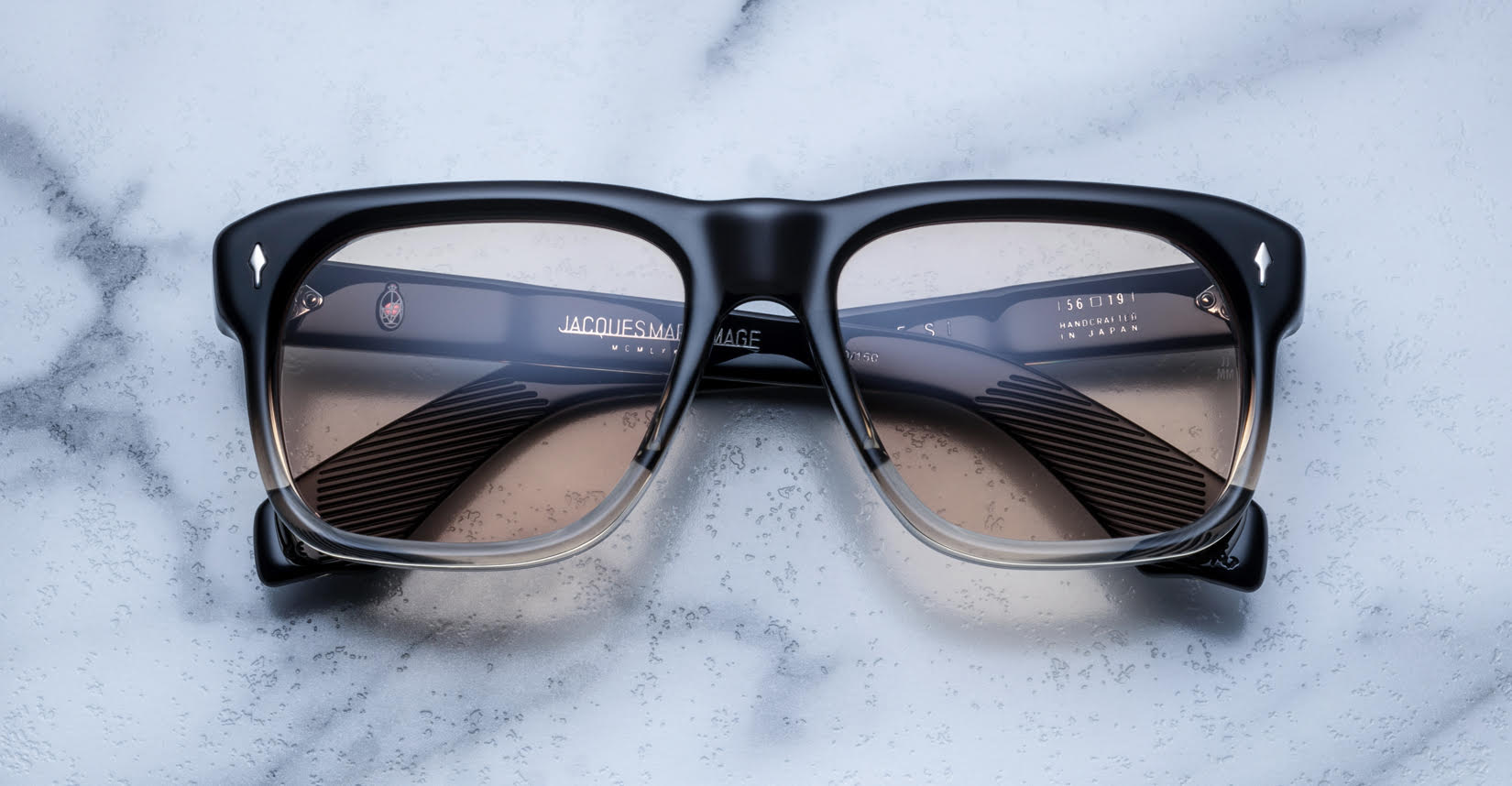 Jacques Marie Mage Yves rectangular black and clear eyeglasses with tinted lenses, front view.