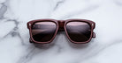 Jacques Marie Mage Yves in Bordeaux Empire sunglasses, rectangular deep red acetate frame with rose-tinted lenses and signature arrowhead rivets, front view