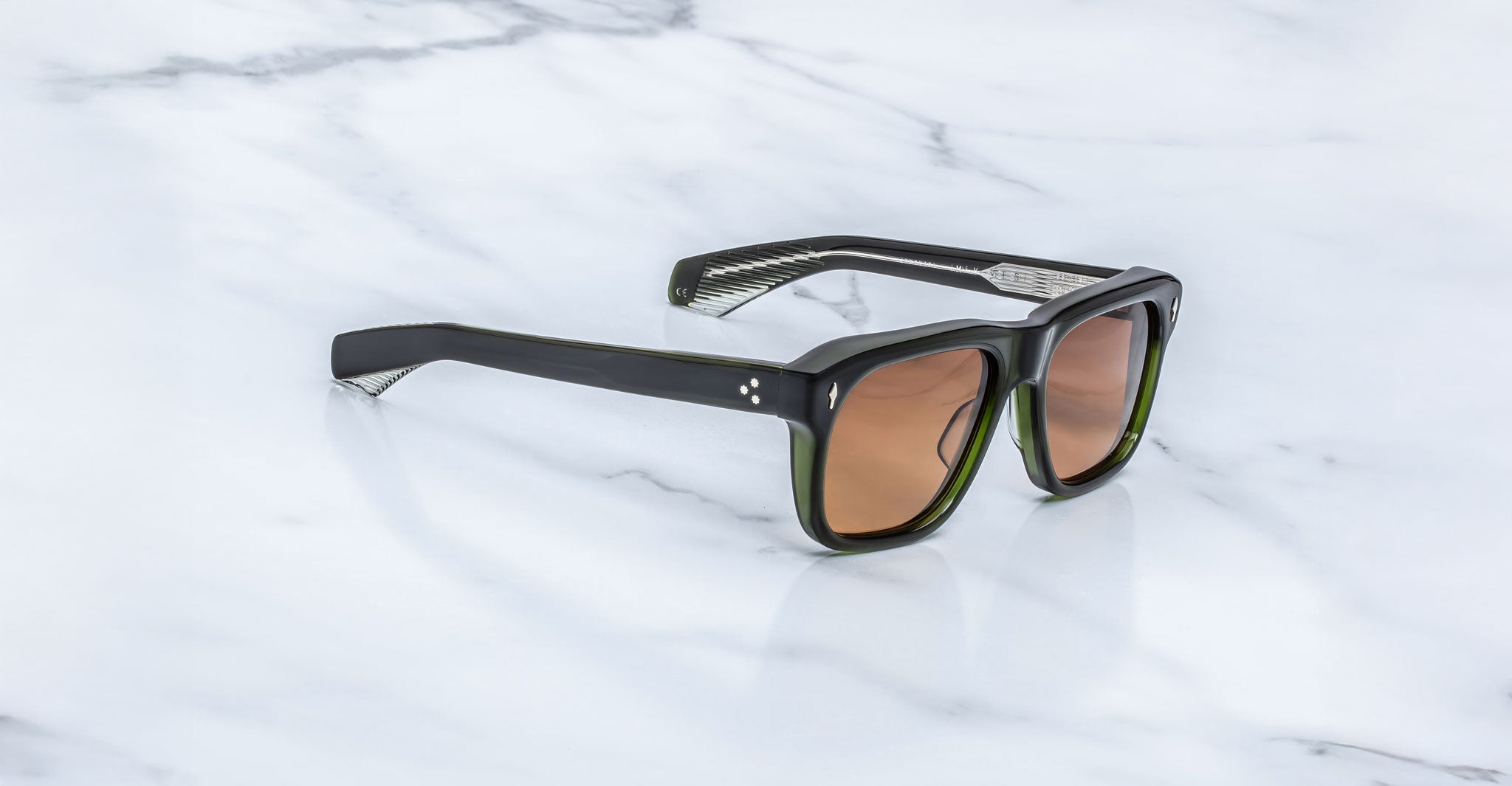 Jacques Marie Mage Yves black rectangular sunglasses with brown lenses, top view.