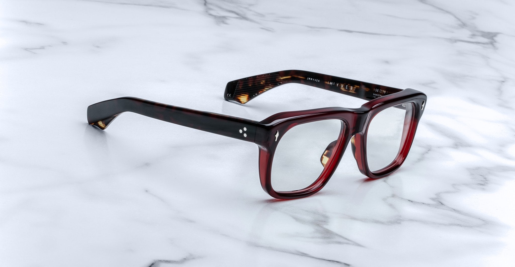 Jacques Marie Mage Yves rectangular dark red tortoiseshell eyeglasses with clear lenses, top view.
