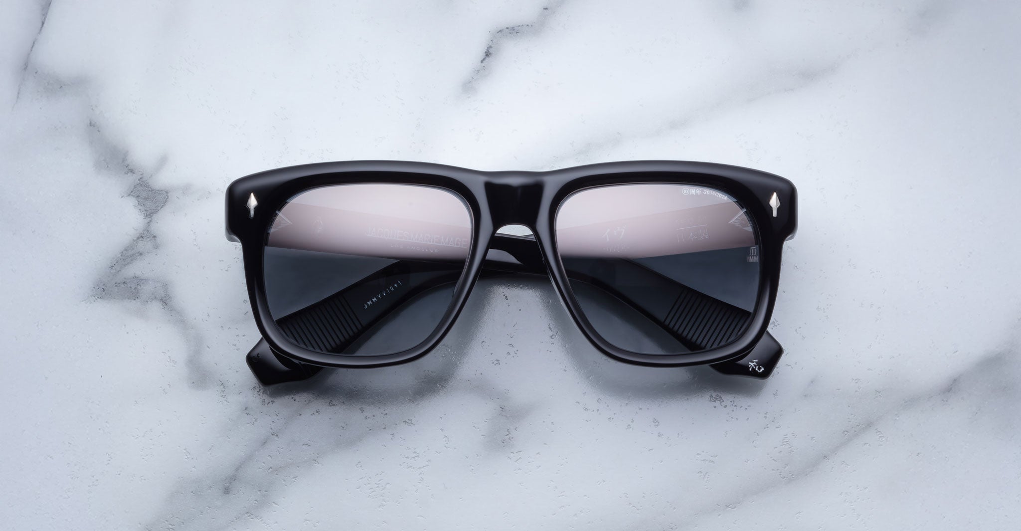 Jacques Marie Mage Yves black rectangular sunglasses with tinted lenses, top view.