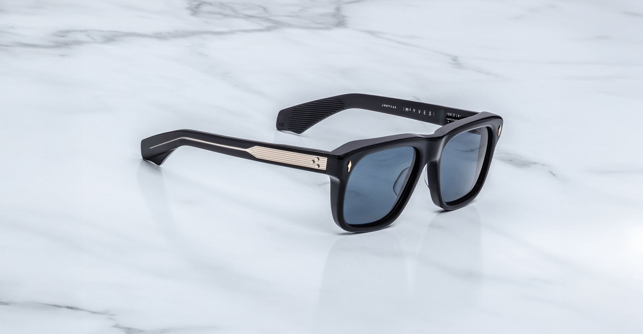 Jacques Marie Mage Yves in Lacquer Blue sunglasses, rectangular dark blue acetate frame with blue-tinted lenses, signature arrowhead rivets, and engraved metal core temples, angled side view