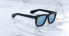 Jacques Marie Mage Yves black rectangular sunglasses with blue lenses, front view.