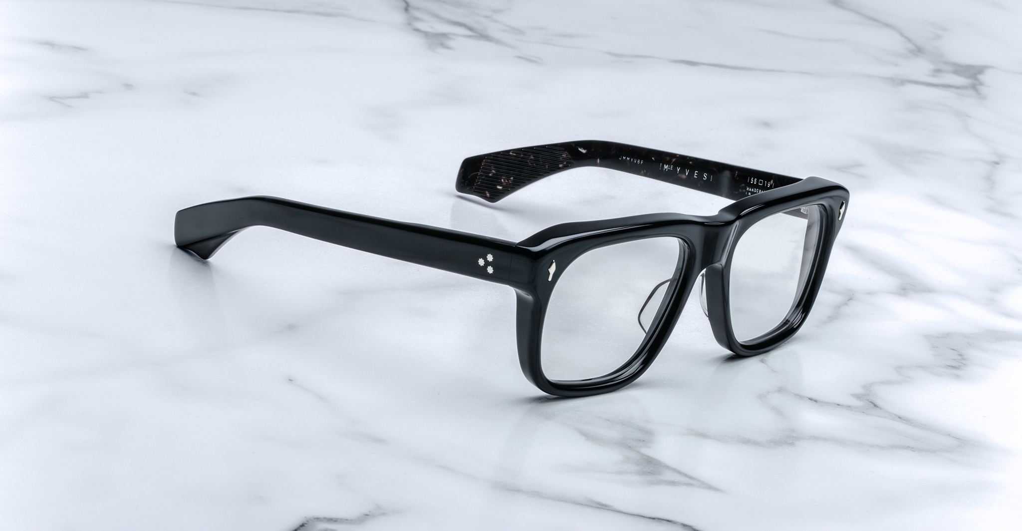Jacques Marie Mage Yves black rectangular eyeglasses with clear lenses, product shown from above.