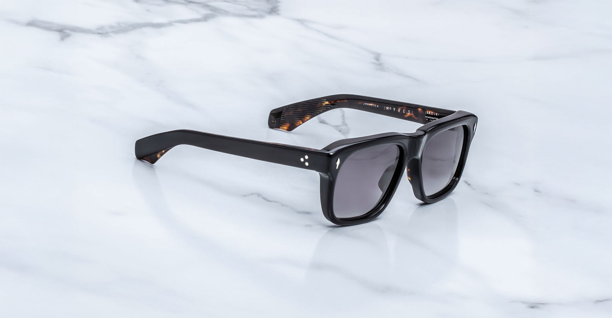 Jacques Marie Mage Yves black rectangular sunglasses with UV-protective lenses, top view.