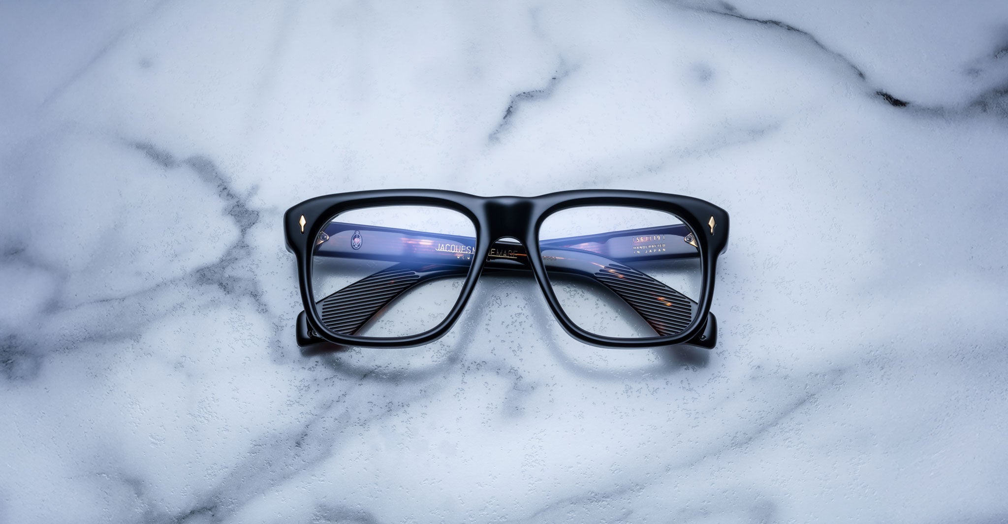 Jacques Marie Mage Yves black eyeglasses with clear lenses, front view. Eyeglass frame features rectangular shape.