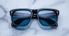 Jacques Marie Mage Yves black rectangular eyeglasses with blue-light lenses, top view.