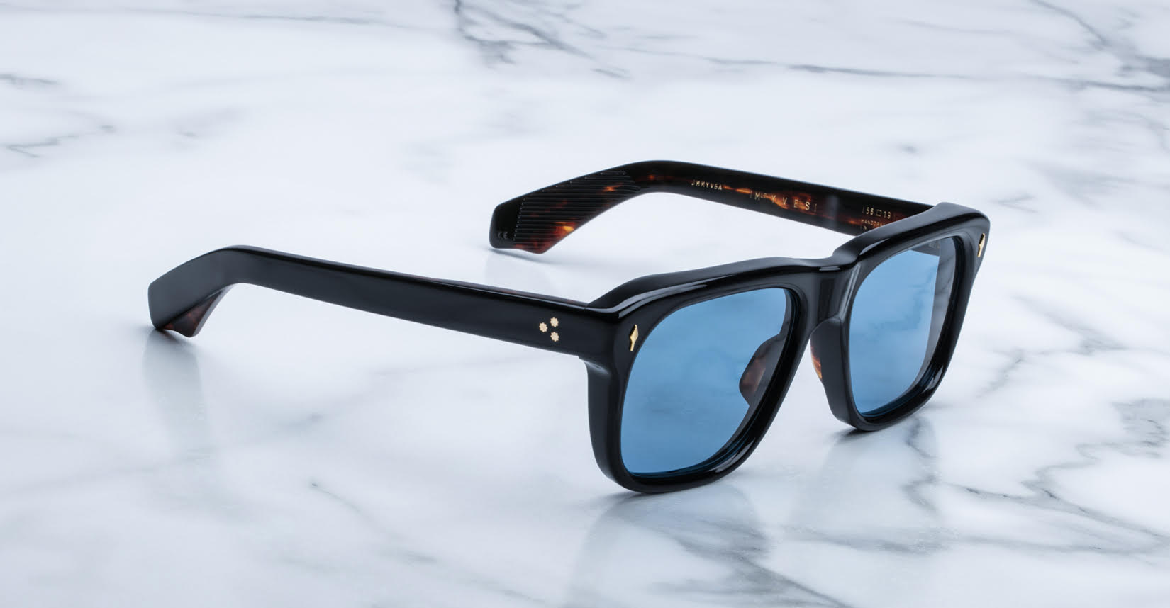 Jacques Marie Mage Yves black rectangular sunglasses with blue lenses, side view.