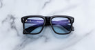 Jacques Marie Mage Yves in Obscure Black sunglasses, rectangular matte black acetate frame with blue-tinted lenses and signature arrowhead rivets, front view