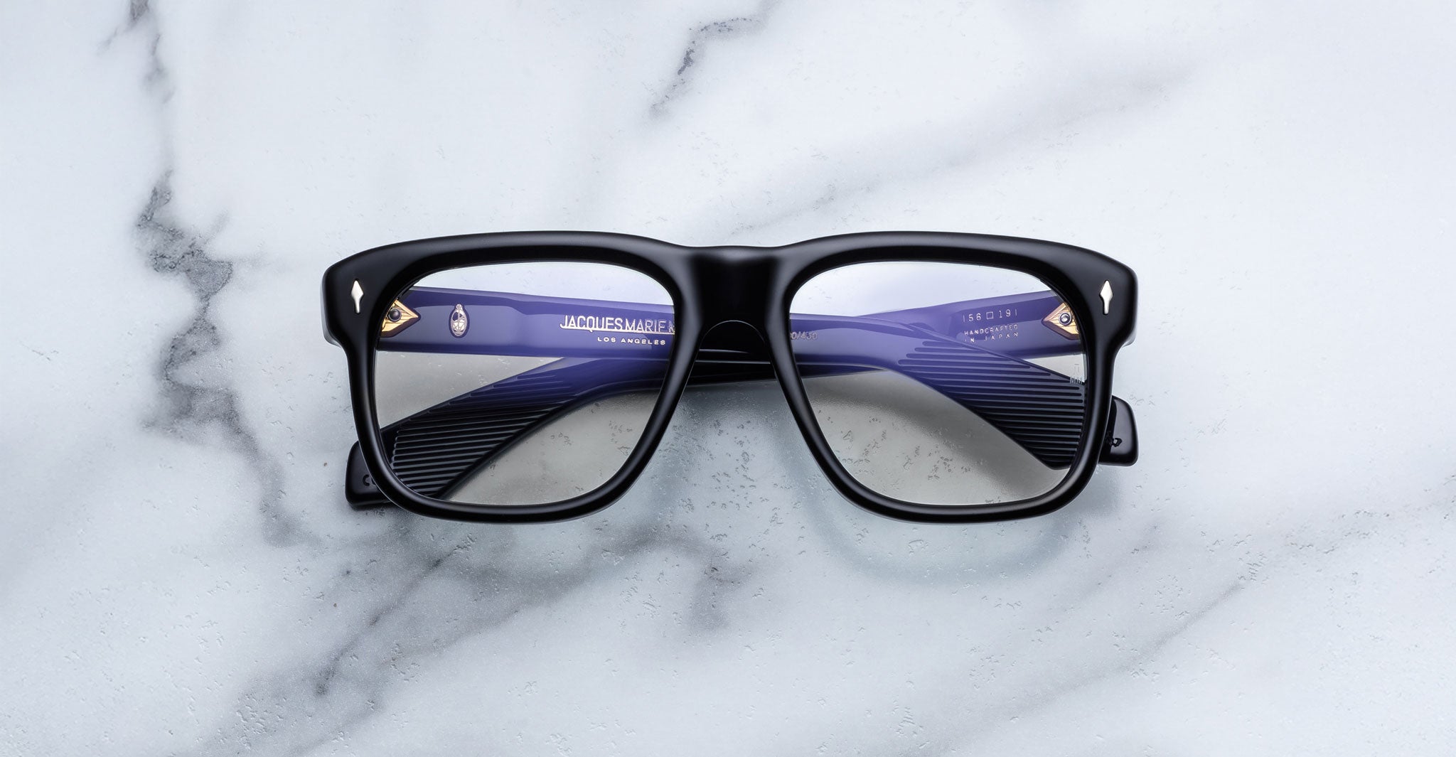 Jacques Marie Mage Yves in Obscure Black optical frame, rectangular matte black acetate frame with clear lenses and signature arrowhead rivets, front view