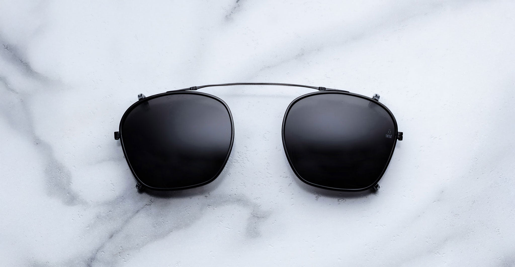 Jacques Marie Mage Zephirin 47 Clip On 2 black sunglasses with thin metal bridge, top view.