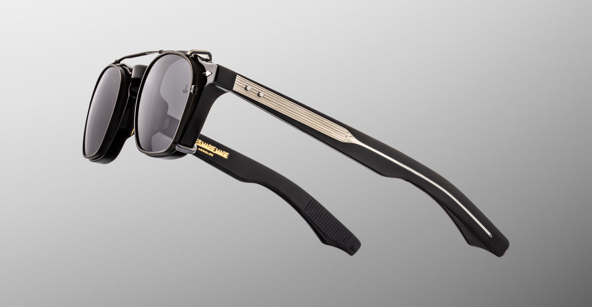 Jacques Marie Mage Zephirin 47 Clip On 2 black sunglasses, gold accents, ornate arms, front and side view visible.
