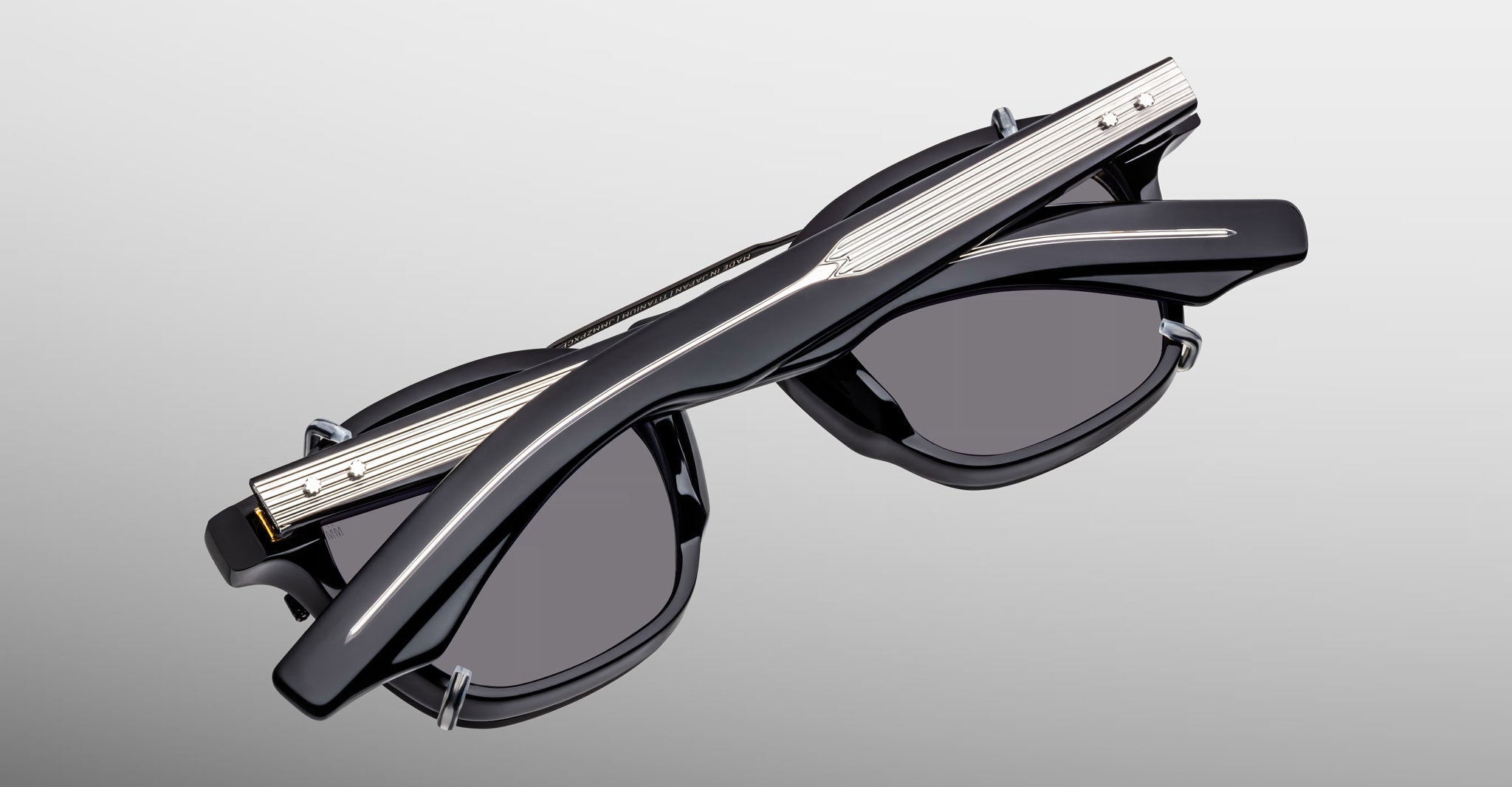 Jacques Marie Mage Zephirin 47 Clip On 2 sunglasses with silver accents on black frames, shown from the front angle.