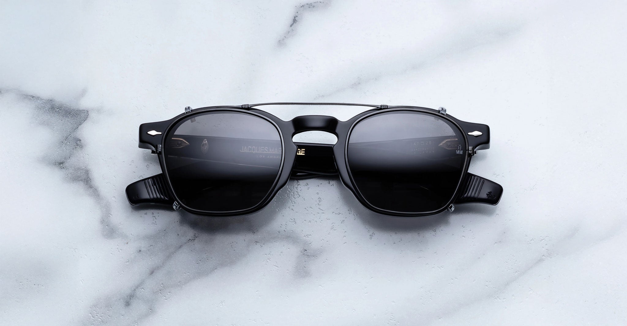 Jacques Marie Mage Zephirin 47 Clip On 2 black polarized sunglasses with dark lenses, top view.