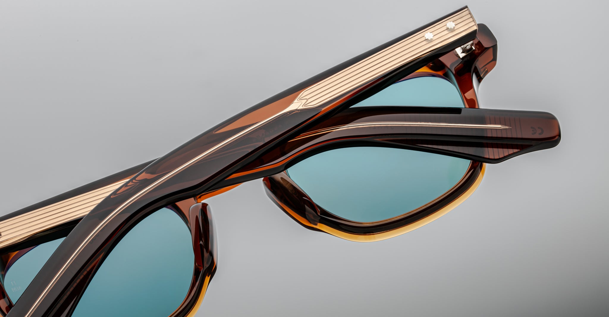 Jacques Marie Mage Zephirin 47 tortoiseshell sunglasses with blue lenses, shown in two stacked pairs, viewed from above.