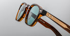 Close-up of Jacques Marie Mage Zephirin 47 sunglasses, showing blue polarized lenses and gold accents from a front angle.