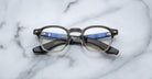 Jacques Marie Mage Zephirin 47 round eyeglasses, black and clear frame, front angle view.