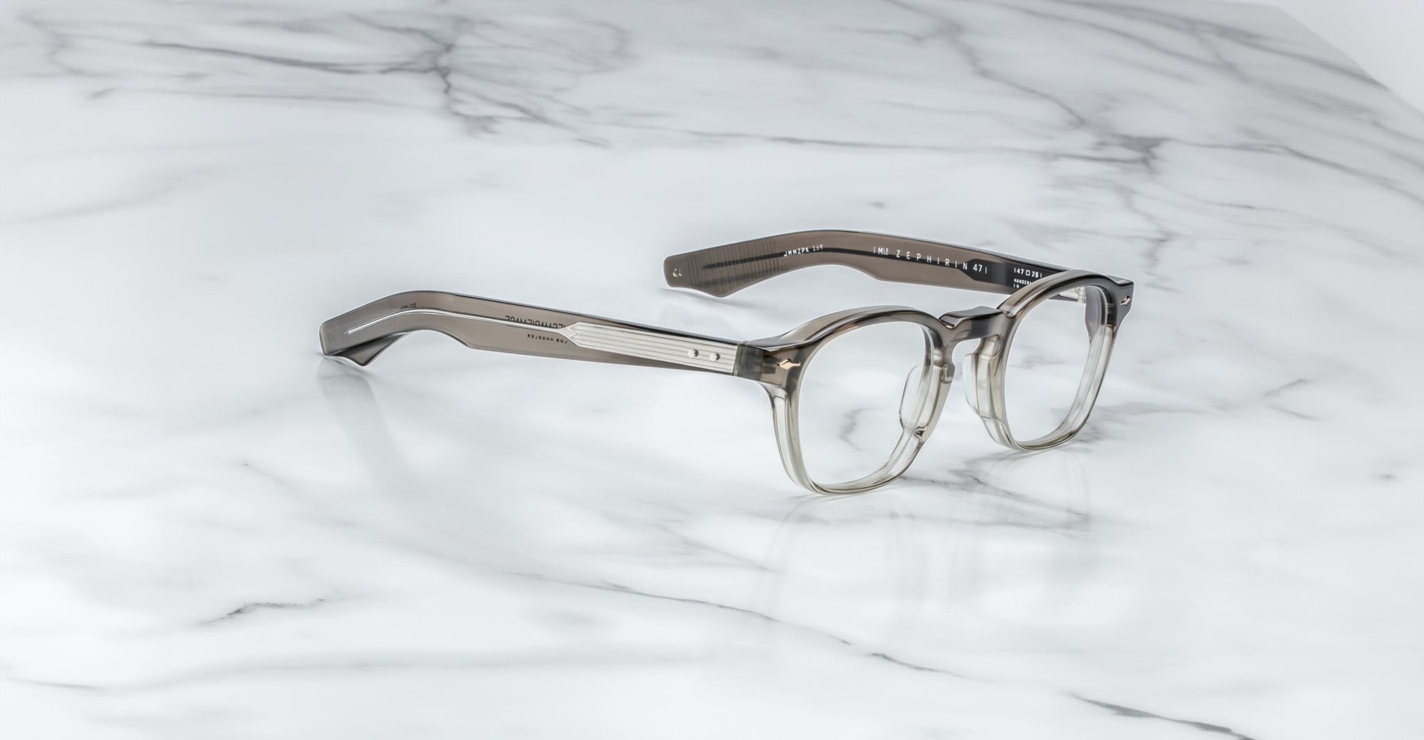 Jacques Marie Mage Zephirin 47 round gray transparent eyeglasses, top view, displayed on a flat surface.