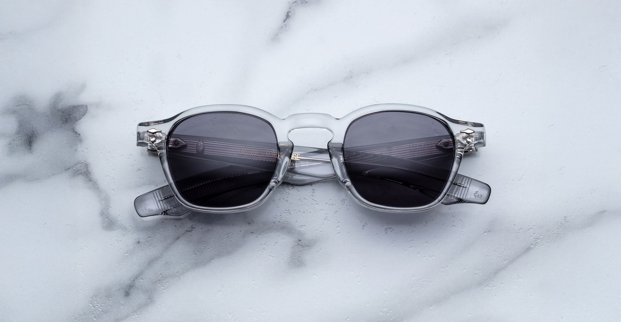 Jacques Marie Mage Zephirin 47 sunglasses with gray frames and dark lenses, top view.