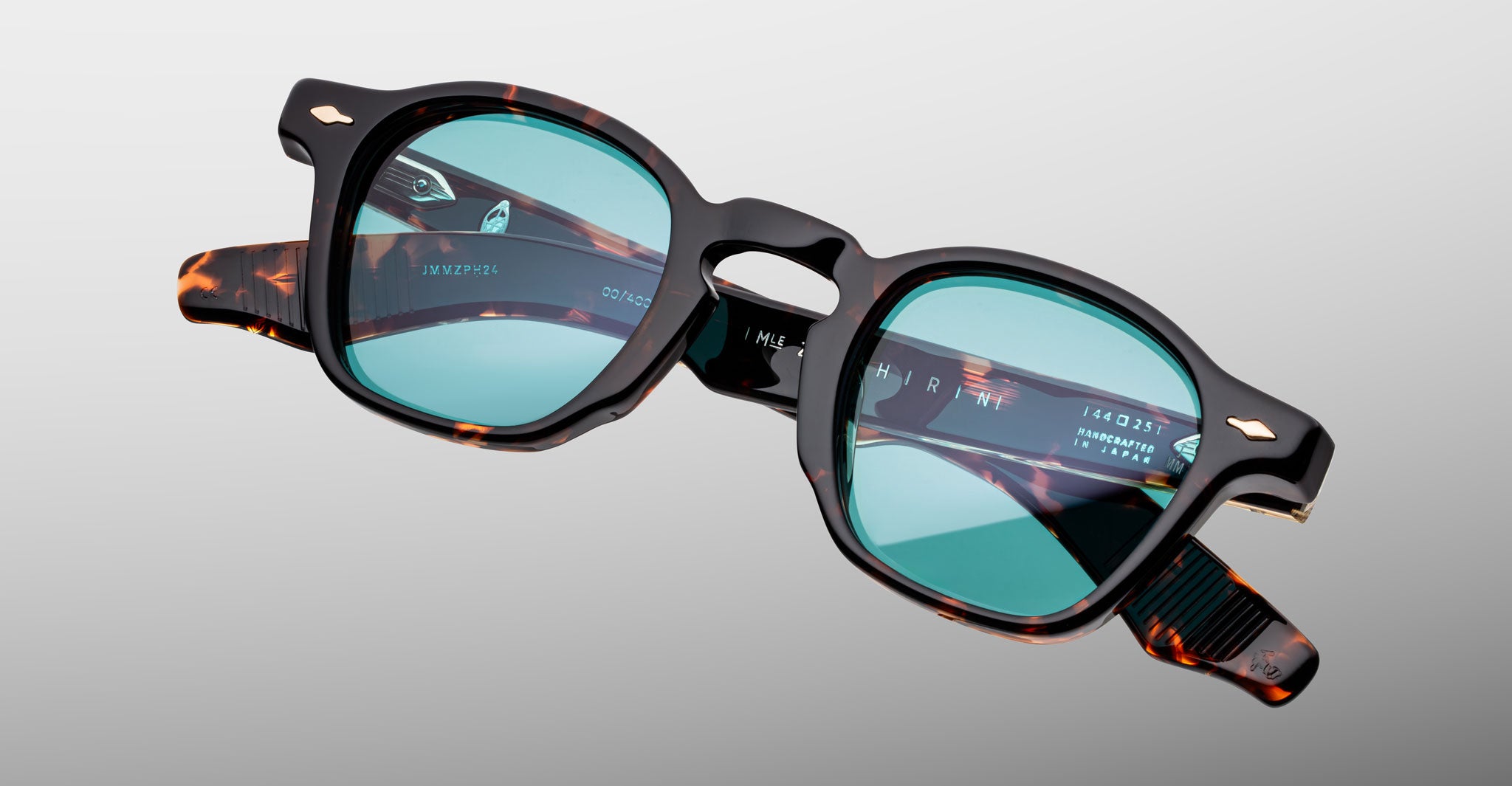 Jacques Marie Mage Zephirin sunglasses in Aegen, angled detail view with turquoise lenses and tortoiseshell acetate accents.