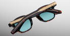 Jacques Marie Mage Zephirin sunglasses in Aegen, rear detail showing dark tortoiseshell acetate temples and gold-tone wirecore hardware.