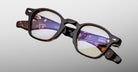 Jacques Marie Mage Zephirin optical frame in Aegen, angled front detail showing dark tortoiseshell acetate and gold-tone accents.
