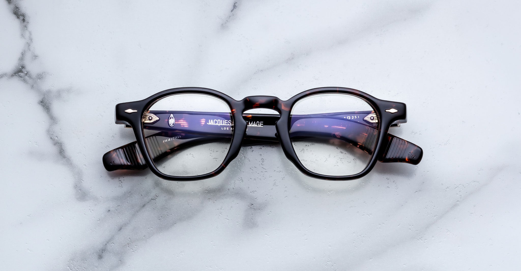 Jacques Marie Mage Zephirin optical frame in Aegen, front view with clear lenses, dark tortoiseshell acetate, and gold-tone accents.