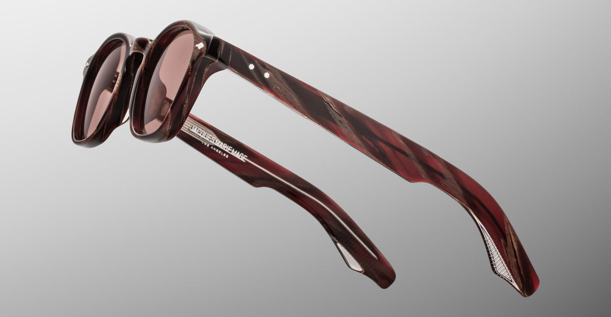 Jacques Marie Mage Zephirin sunglasses in Auburn, side detail showing reddish-brown marbled acetate temples, rose-tinted lenses, and silver-tone wirecore accents.