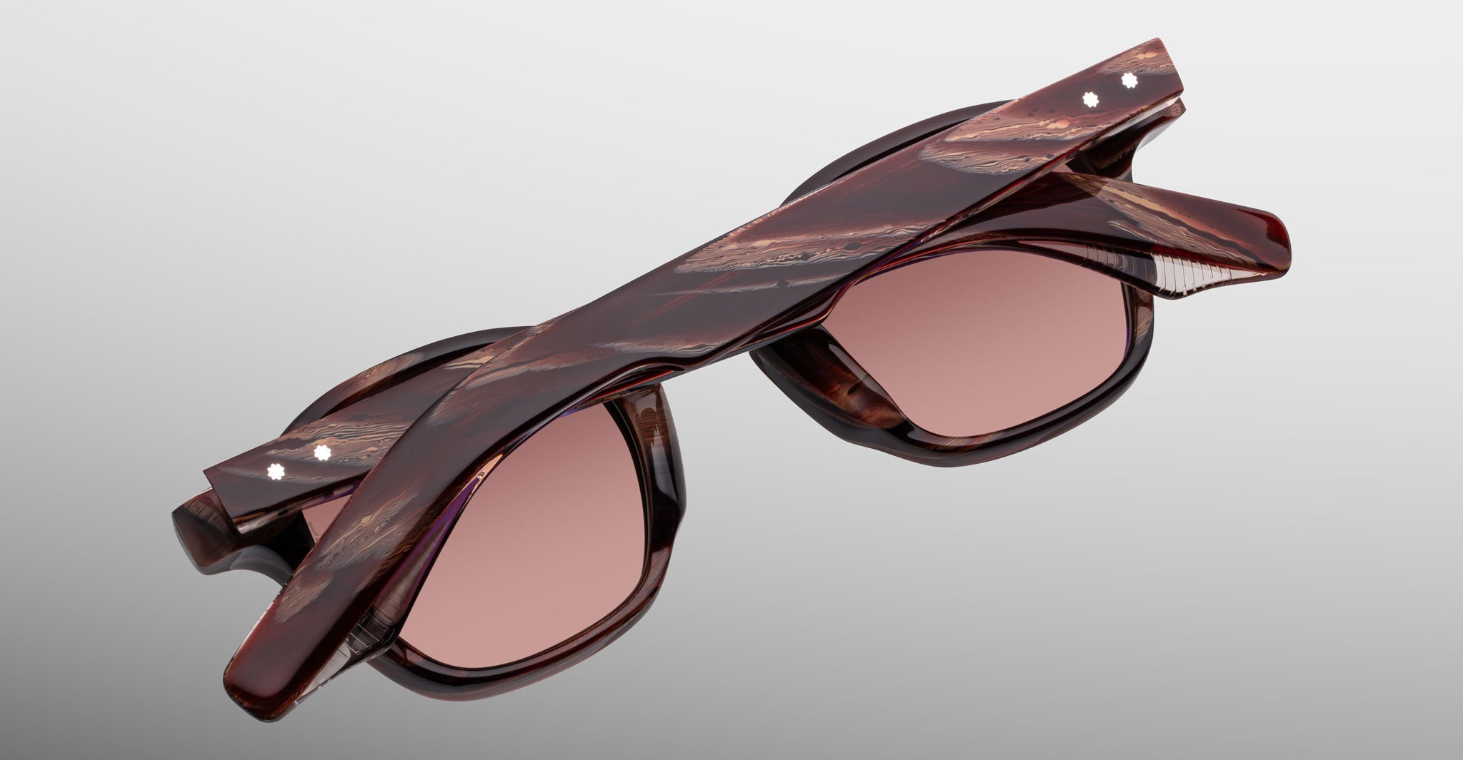 Jacques Marie Mage Zephirin sunglasses in Auburn, rear detail showing reddish-brown marbled acetate, rose-tinted lenses, and exposed temple hardware.