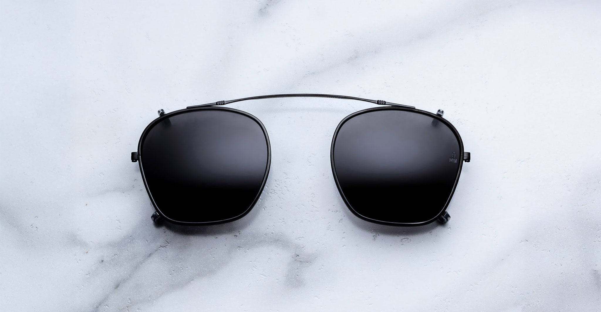 Jacques Marie Mage Zephirin Clip On 2 sunglasses shown from above, highlighting the frame design and brand details.