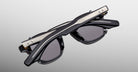 Jacques Marie Mage Zephirin Clip On 2 black sunglasses with silver temple details, shown from a front angle.