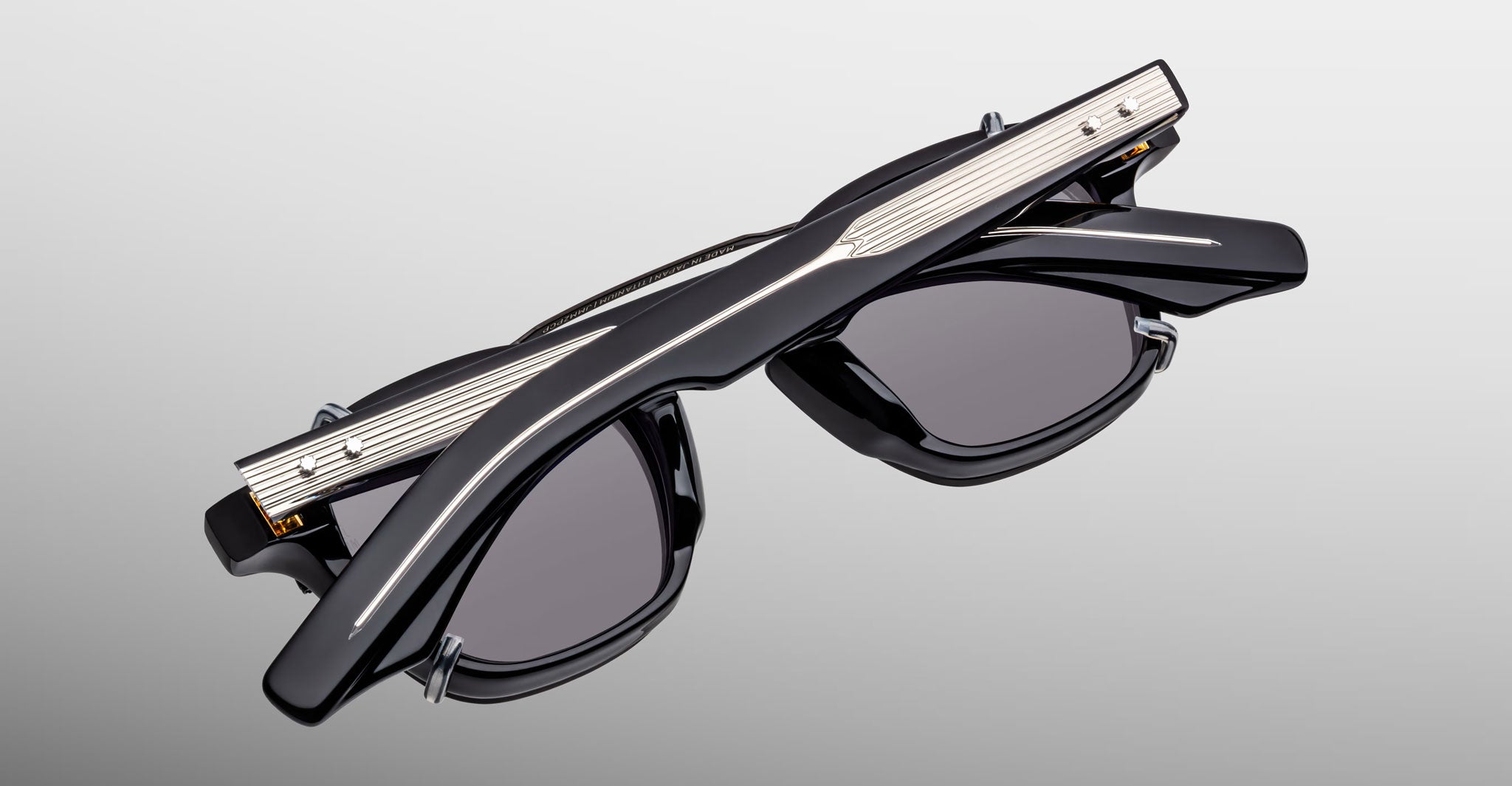 Jacques Marie Mage Zephirin Clip On 2 black sunglasses with silver temple details, shown from a front angle.