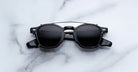 Jacques Marie Mage Zephirin Clip On 2 sunglasses with silver accents and UV lenses, shown from above.
