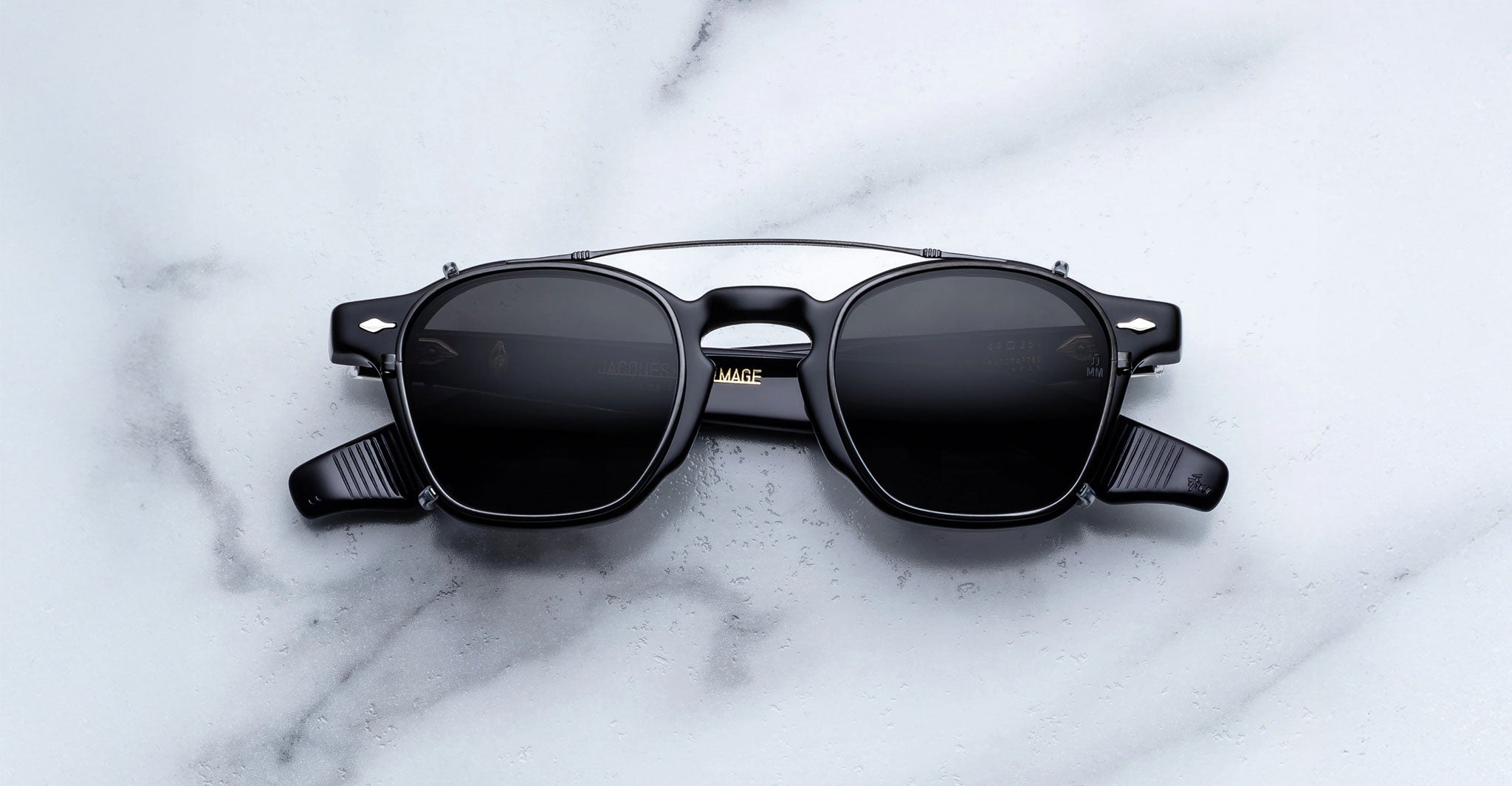 Jacques Marie Mage Zephirin Clip On 2 sunglasses with silver accents and UV lenses, shown from above.