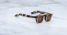 Jacques Marie Mage Zephirin Clip On 2 sunglasses, brown lenses, black-yellow tortoiseshell frames, front view.