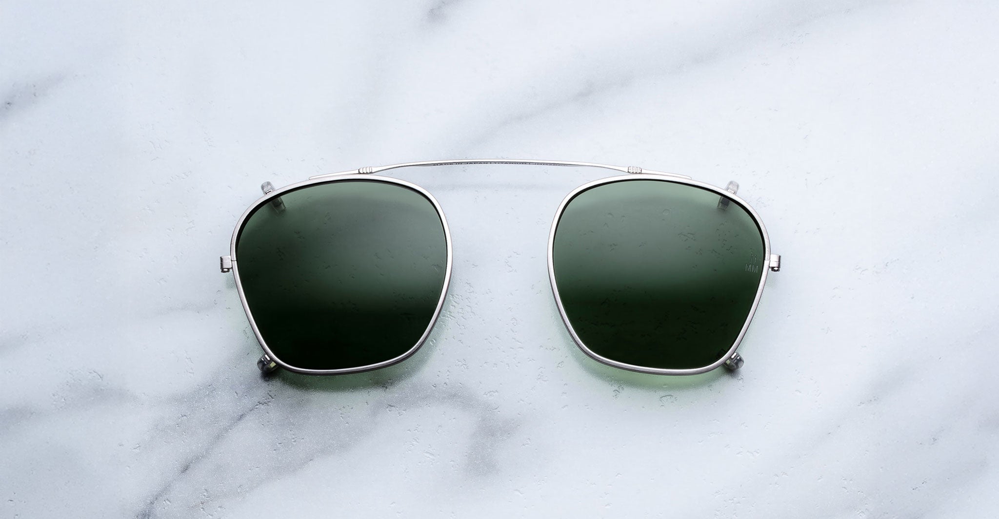Jacques Marie Mage Zephirin Clip On 2 sunglasses with thin metal frame, shown from above.