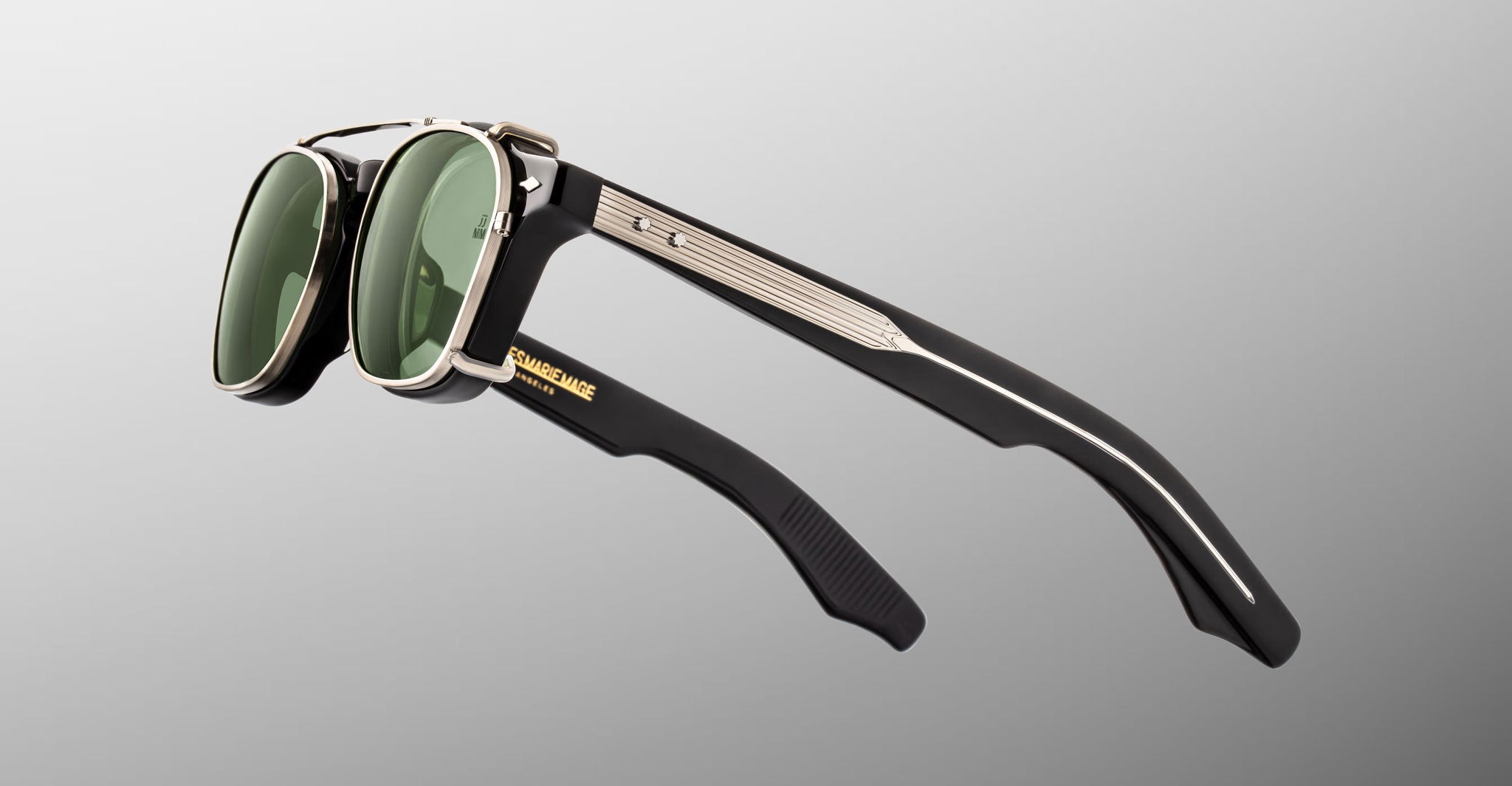 Jacques Marie Mage Zephirin Clip On 2 sunglasses with metallic frames and green lenses, shown from a front angle.