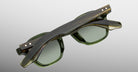 Jacques Marie Mage Zephirin sunglasses in Kombu, rear detail showing translucent olive green acetate, green-tinted lenses, and gold-tone wirecore hardware.