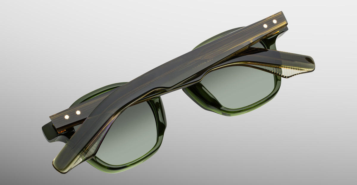 Jacques Marie Mage Zephirin sunglasses in Kombu, rear detail showing translucent olive green acetate, green-tinted lenses, and gold-tone wirecore hardware.