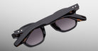 Jacques Marie Mage Zephirin sunglasses in Noir 11, rear detail showing glossy black acetate, gray-tinted lenses, and subtle tortoiseshell accents.