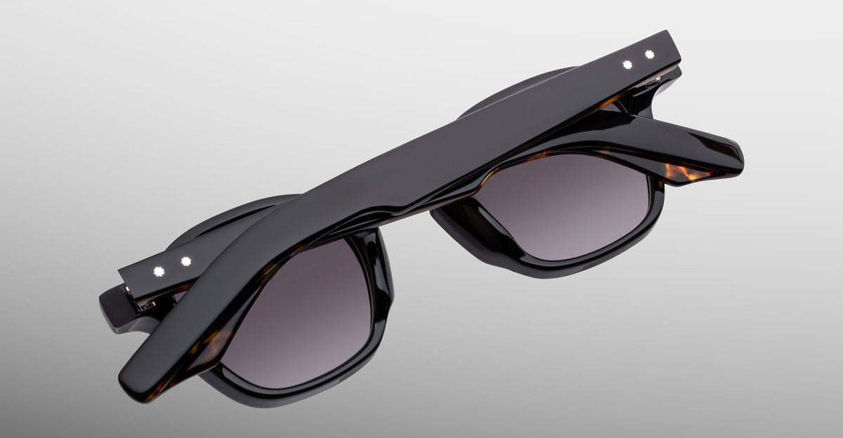 Jacques Marie Mage Zephirin sunglasses in Noir 11, rear detail showing glossy black acetate, gray-tinted lenses, and subtle tortoiseshell accents.
