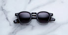 Jacques Marie Mage Zephirin sunglasses in Noir 11, front view with glossy black acetate and gray gradient lenses.