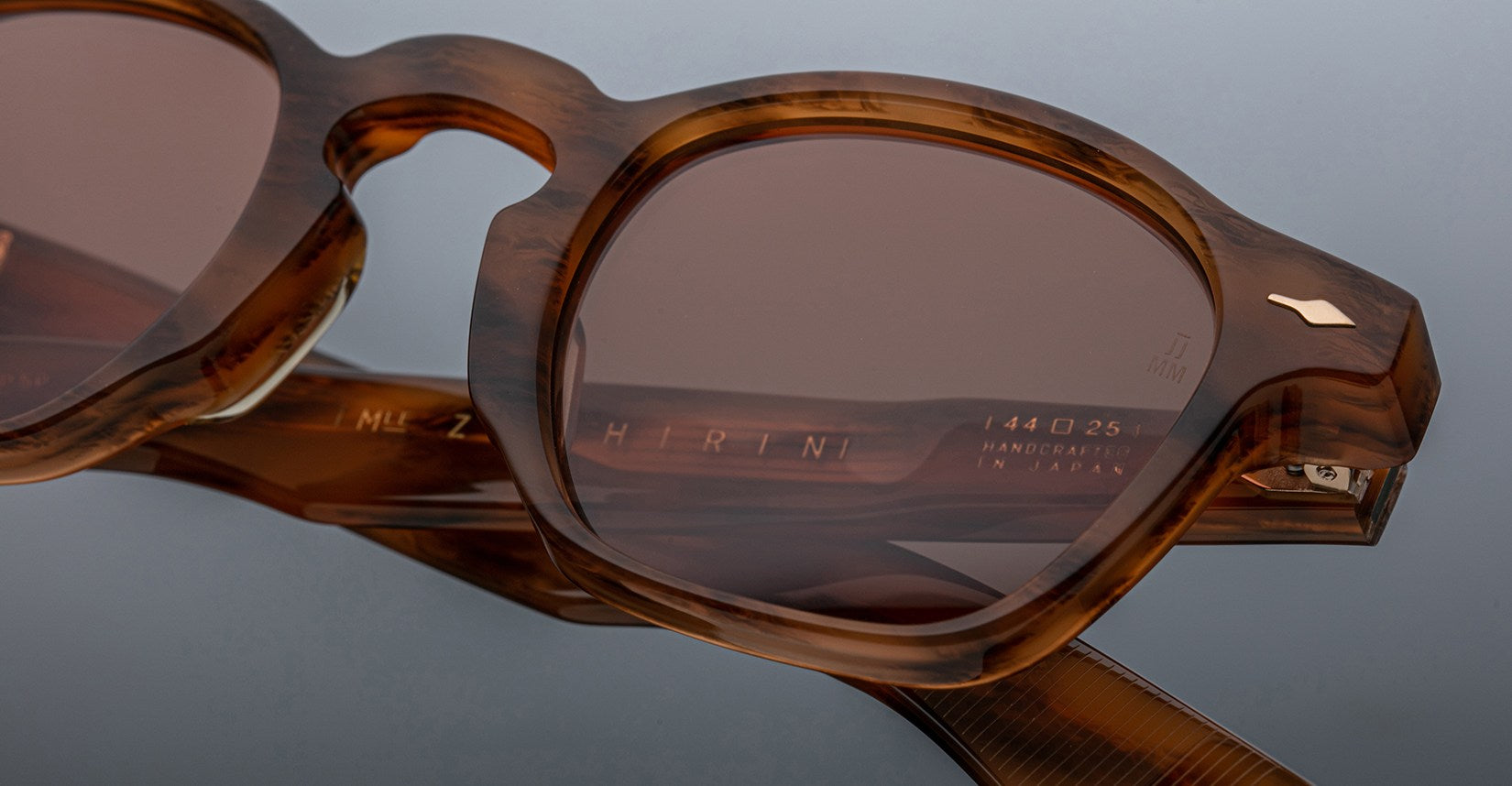 Close-up of Jacques Marie Mage Zephirin sunglasses featuring handcrafted brown tortoiseshell acetate, tinted lenses, and engraved branding on the temple—a refined example of Jacques Marie Mage limited edition eyewear.