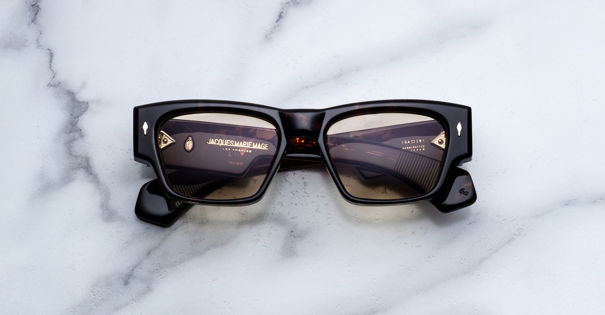 Jacques Marie Mage Agar sunglasses in dark tortoise acetate featuring a bold rectangular frame, warm tinted lenses, and signature arrowhead front pins, front view